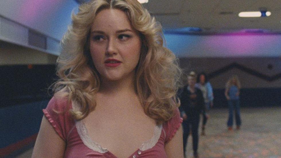 SLUT young woman roller skates in a roller rink.