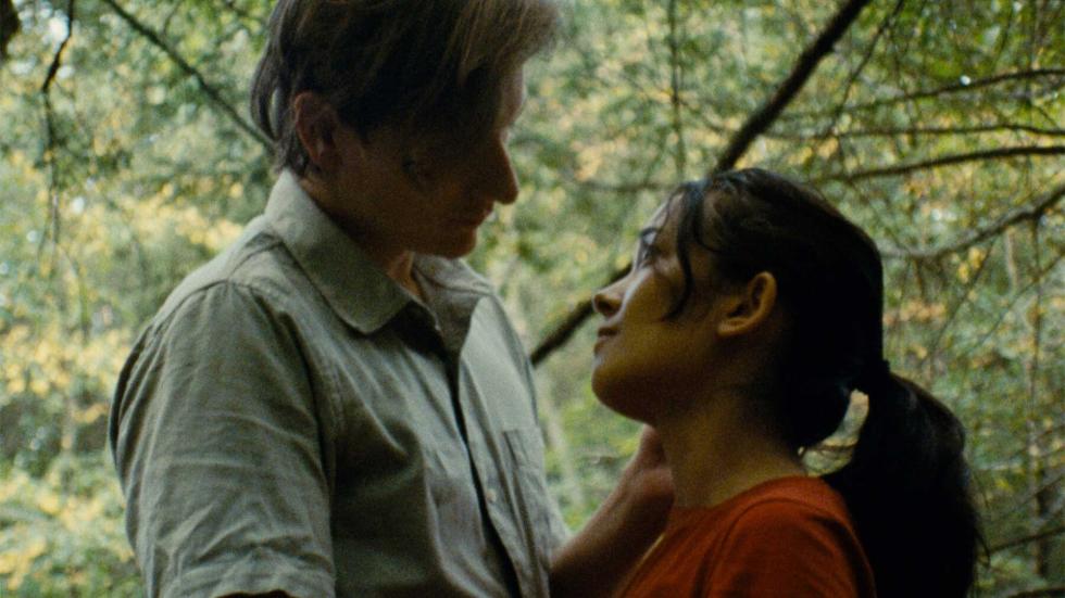 Gordon and Juliette look lovingly at each other in the woods