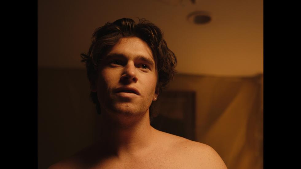 Man looking on in a motel room