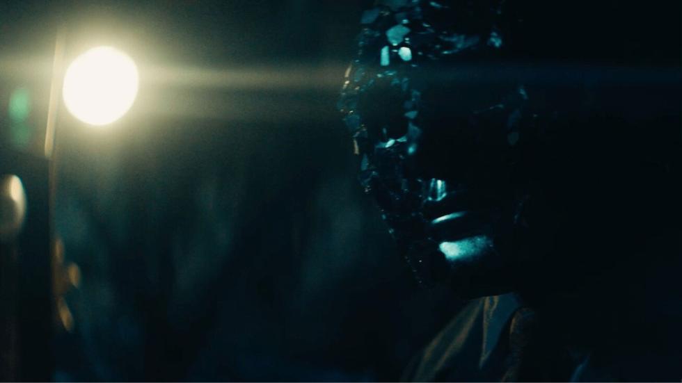 Black faced ghoul looks out