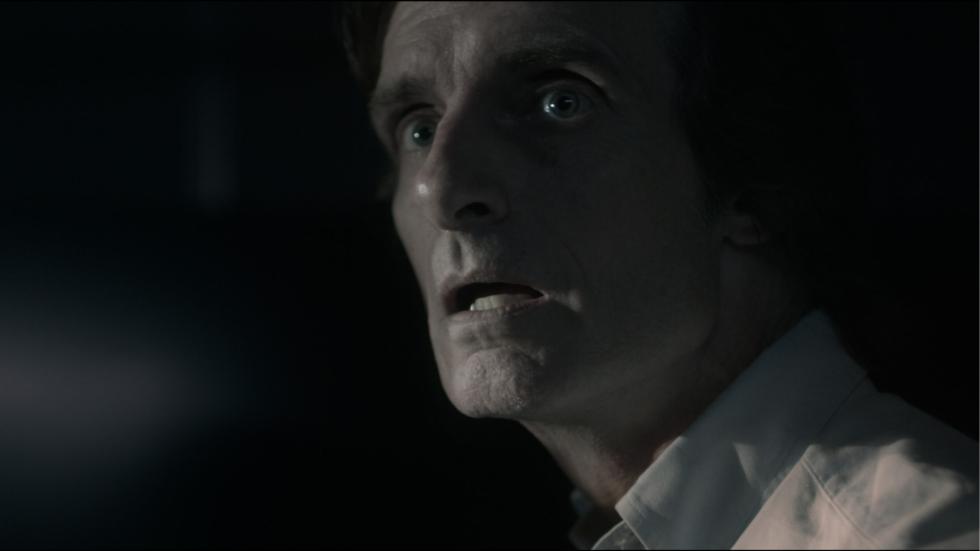 A man looks on scared
