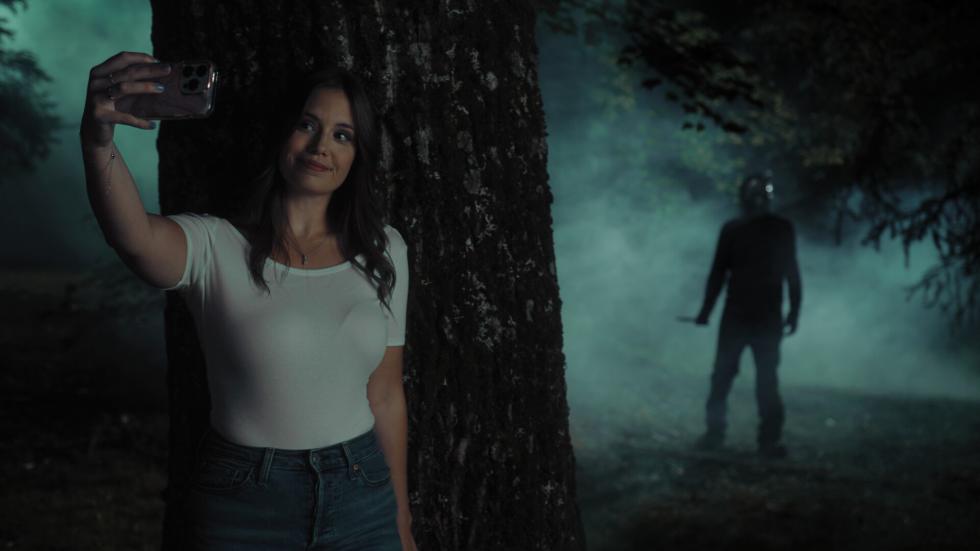 Young woman takes a selfie in the woods