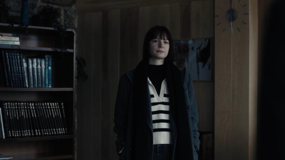 Young woman stands in a room