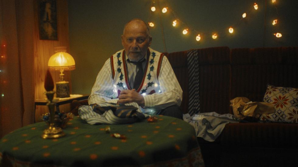 Older man sits at a table