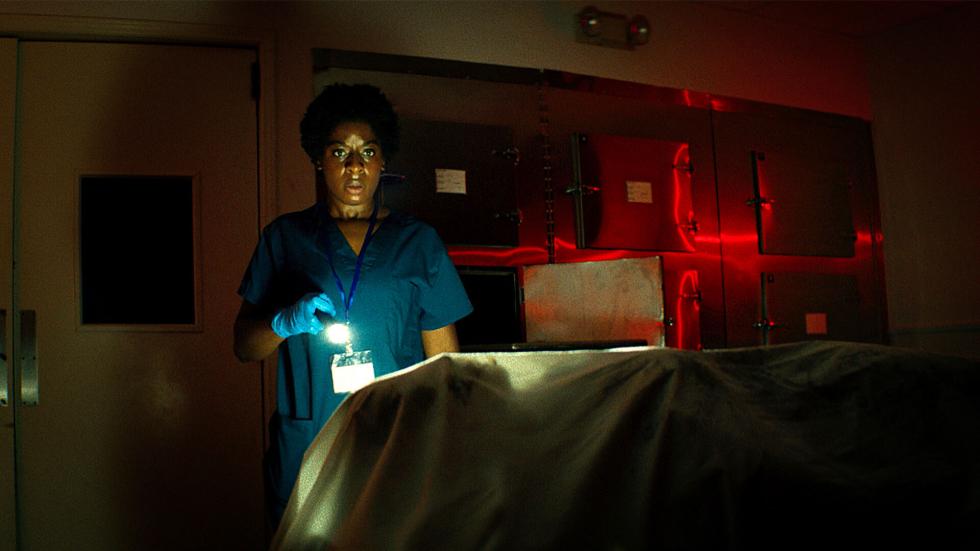 Wake film still woman with a flashlight searches for something