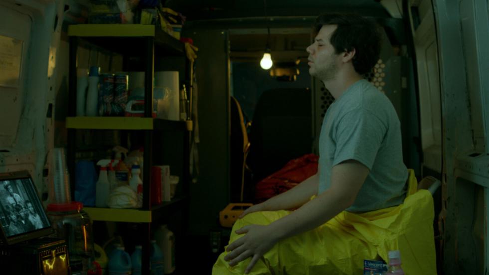 A crime scene cleaner rest in a cleaning supply closet