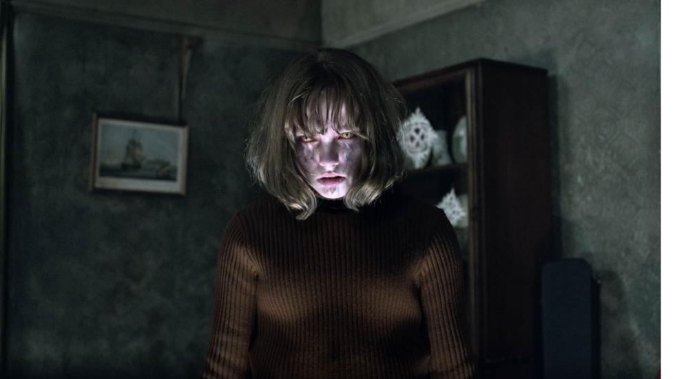 Demonic woman looks on