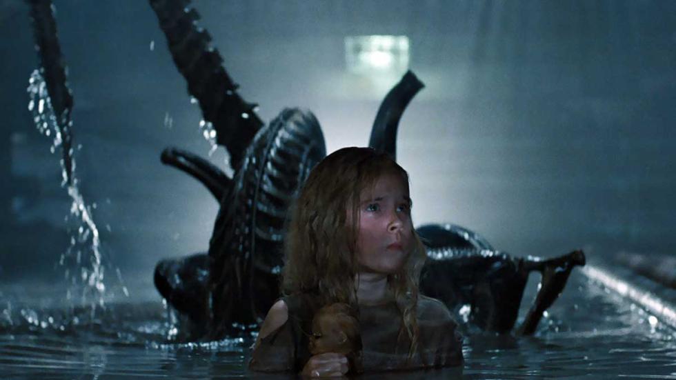 Aliens film still girl with alien behind her