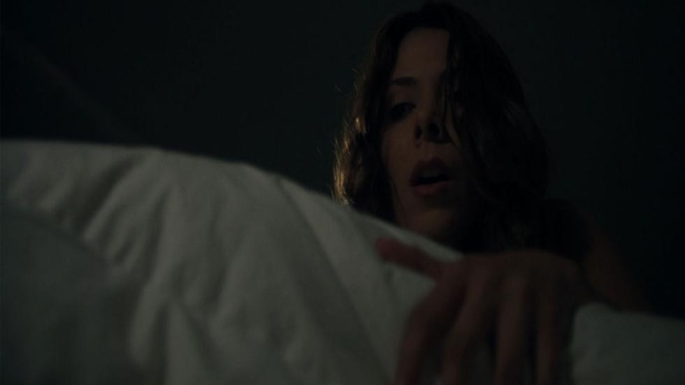 Alone a woman looks under her bed