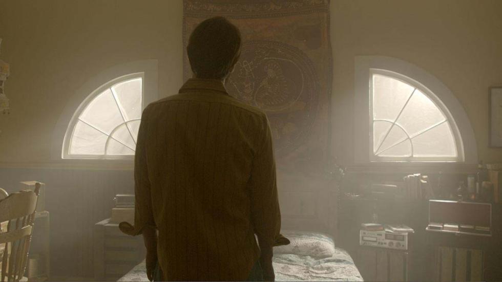 The Amityville Murders film still woman looking out the attic windows