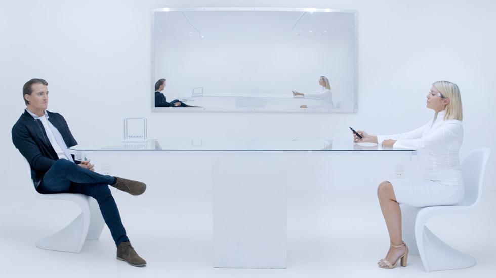 And the Winner is film still couple sitting at a modern table