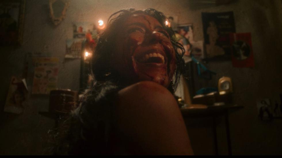 Bloody woman looks up in fear