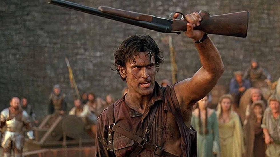 Army of Darkness Ash holds his shotgun over his head