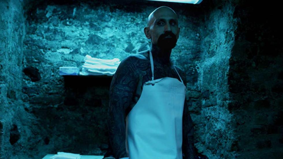 Parlor tattooed man in an apron