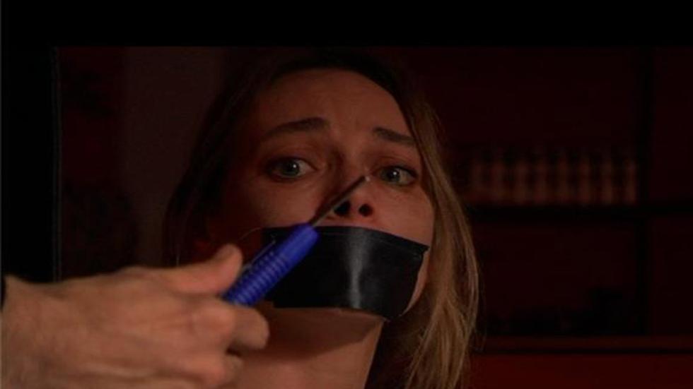 Bad Mistake woman with her mouth taped and being threatened with a knife