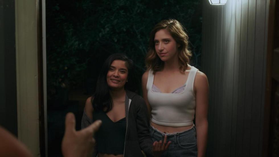 B.E. film still woman speaking to someone in a house.