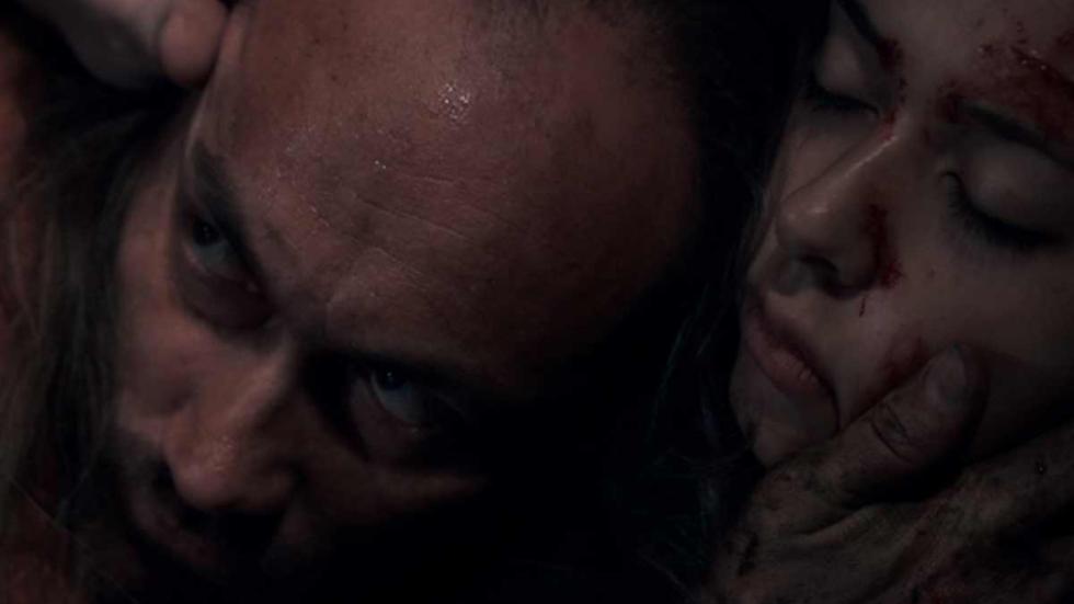 Behind the Bush man holds woman's face