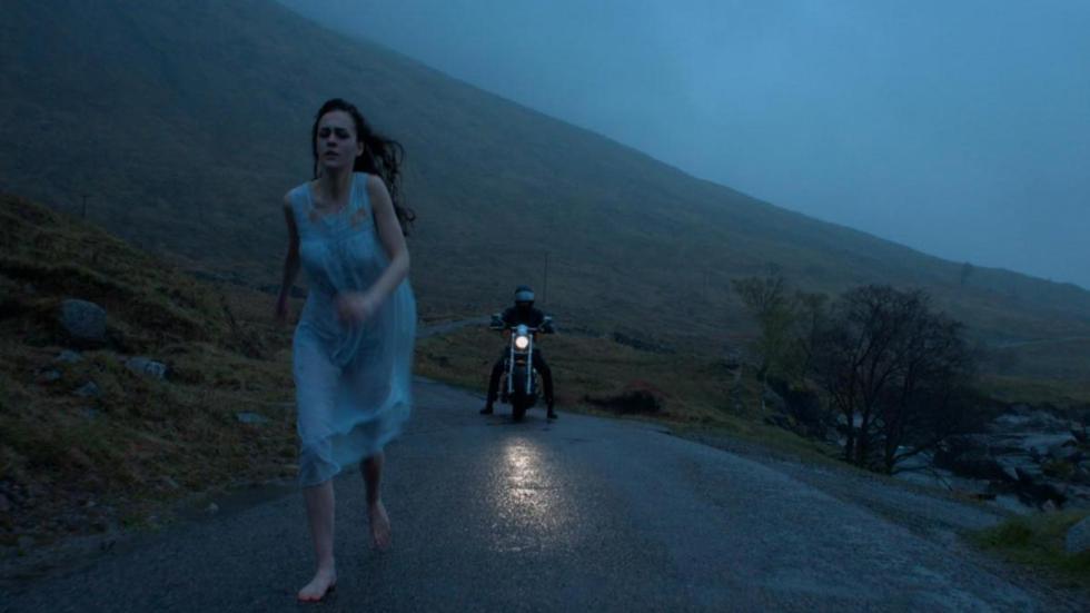 Blackbird film still woman runs in nightgown chased by man on motorcyle