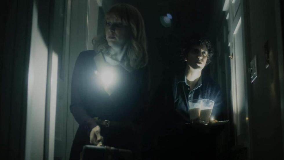 bnb film still couple in a hallway with flashlights