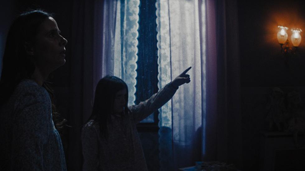 Meat film still of sisters looking at something on the wall