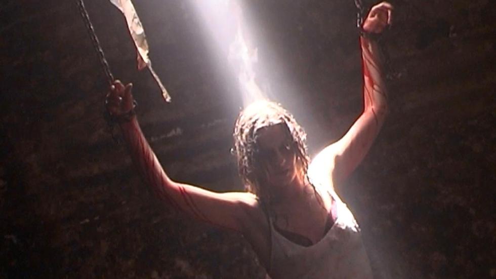 The Chamber woman hangs from chained ar