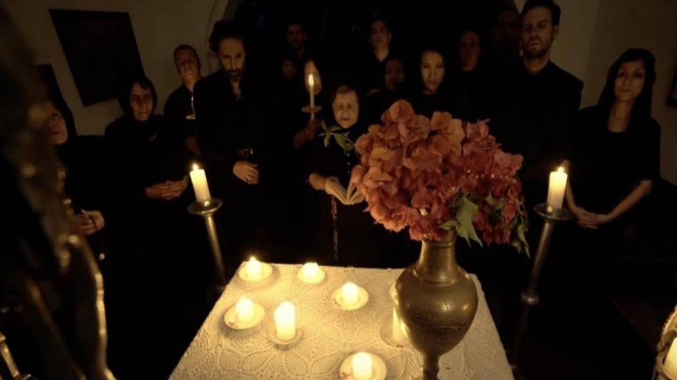 City of Ashes people standing around a table of candles.