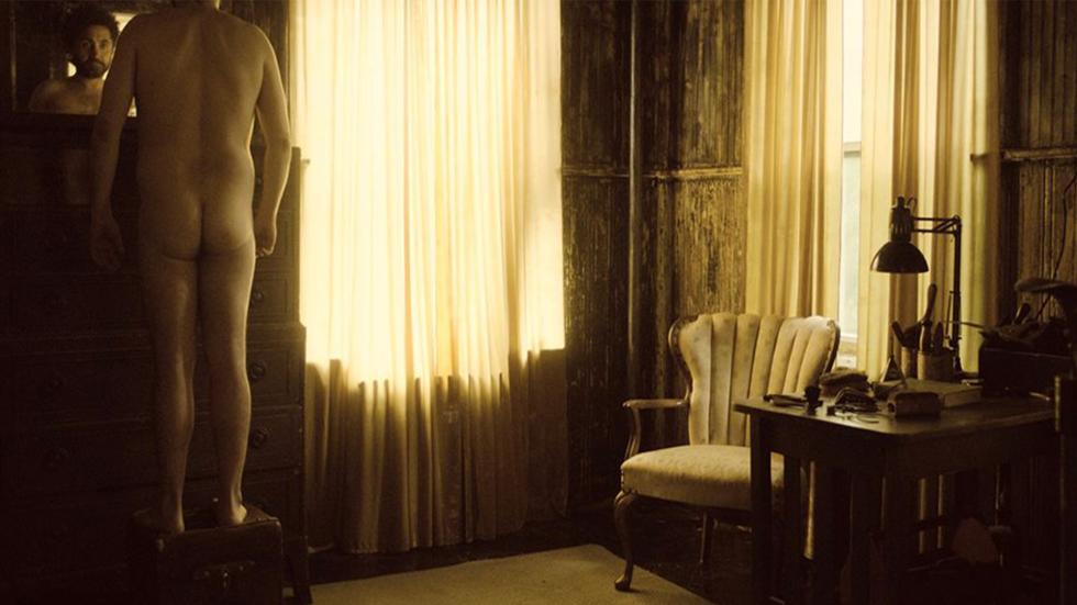 CONSURGO film still naked man looks in a mirror