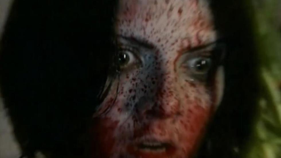 Cradle of Fear A bloodied faced woman looks on in fear