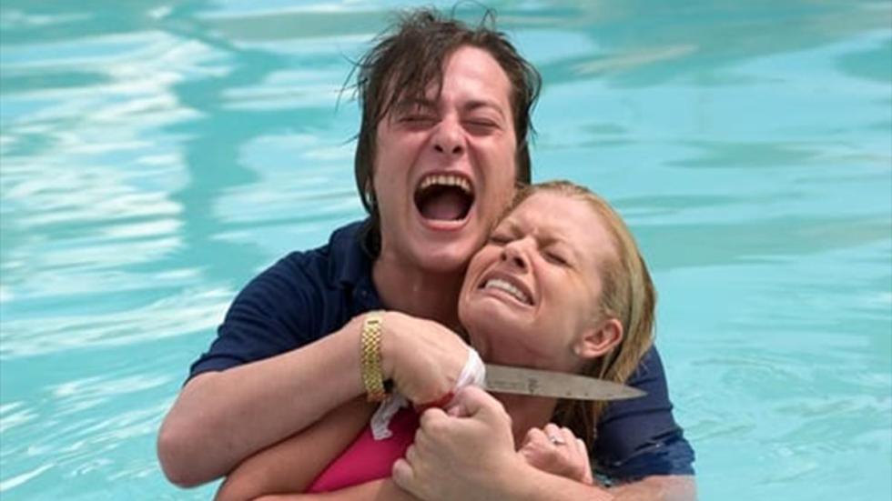Cruel World a man holds a knife to a woman's throat in the swimming pool