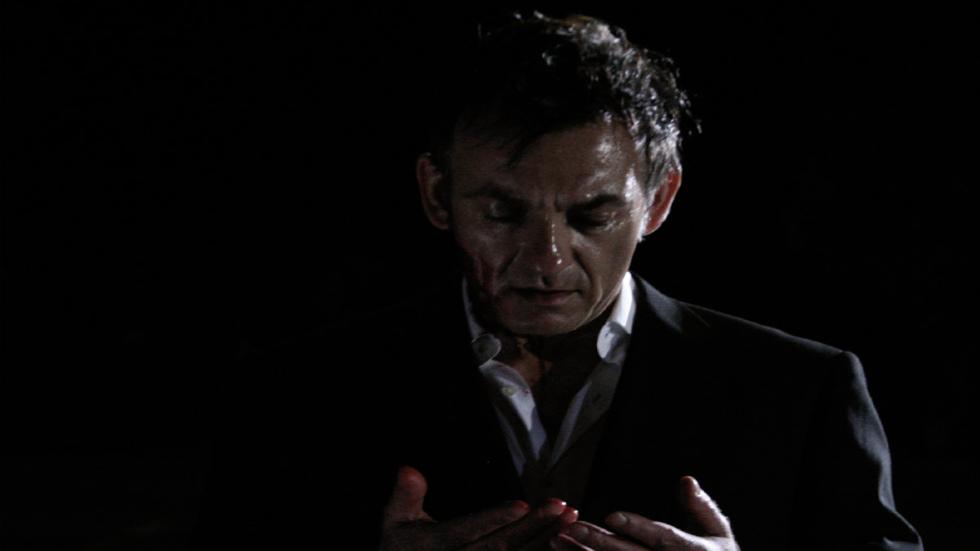 The Room man looks at his bloody hands