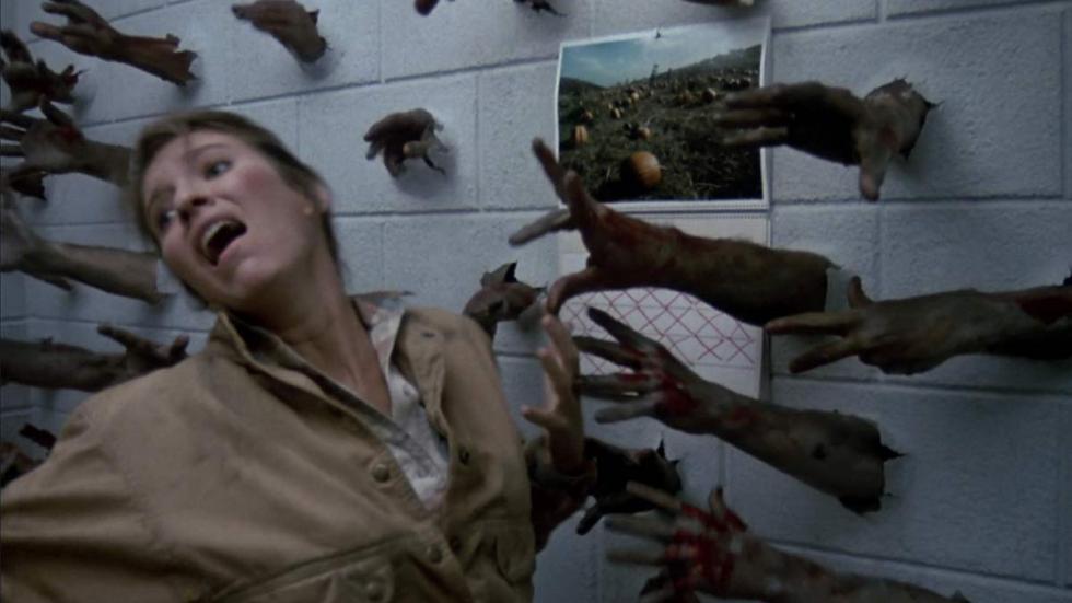 Day of the Dead woman being grabbed by arms in the wall