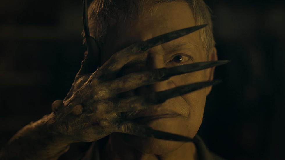 Dead Packet film still creepy hand in front of man's face.