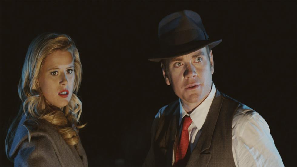 Desolate Road a nicely dressed couple stare at something in fear
