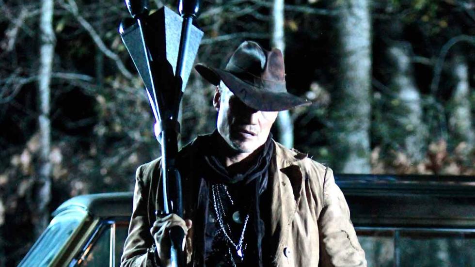 Don't Kill It film still man holds weapon 