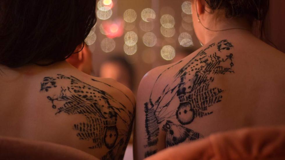 Double Date tattooed backs