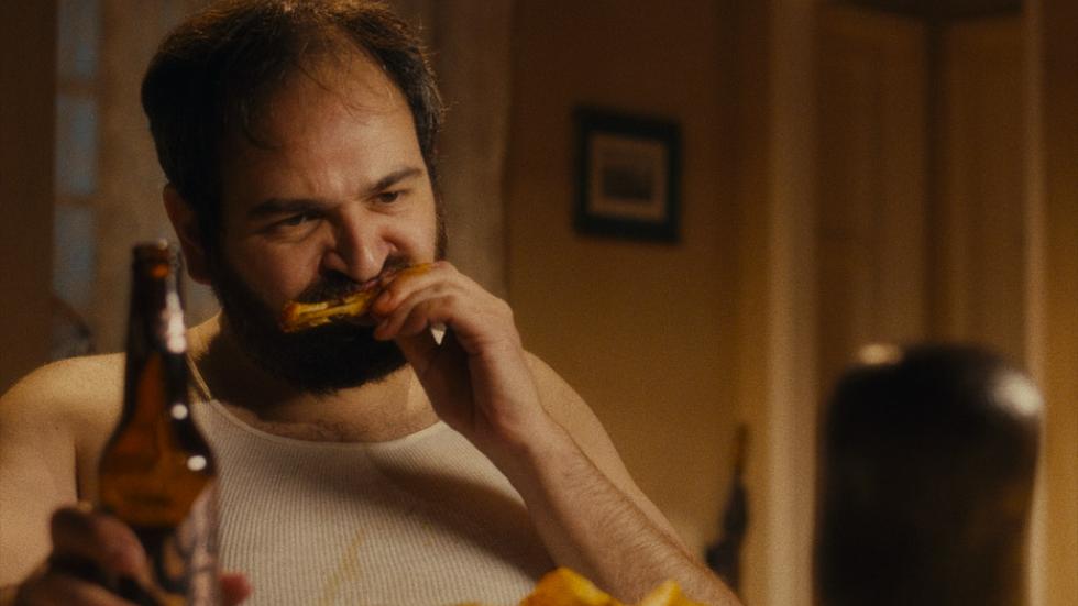 The Occupant film still of a man eating