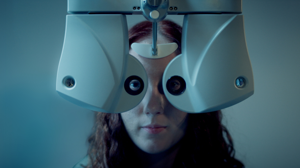 Young woman has her eyes examined