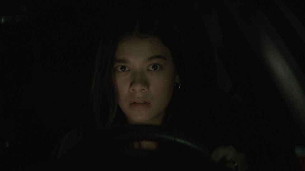 Young woman drives at night