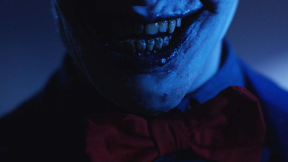 Bedeviled film still smiling creepy creature man
