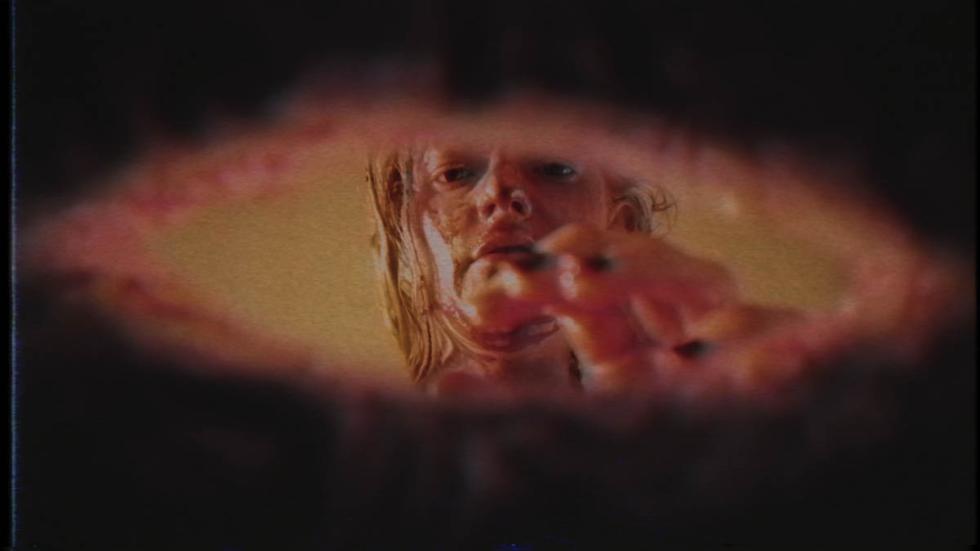 The Last Junkie on Earth bloodied woman reaches for something
