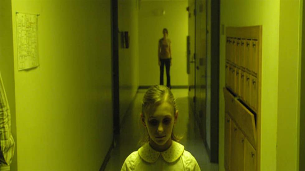 Fingerprints creepy girl stands in a hallway