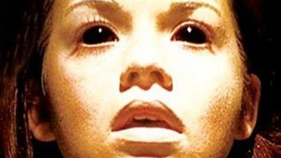 Ghostwatcher woman with black eyes stares