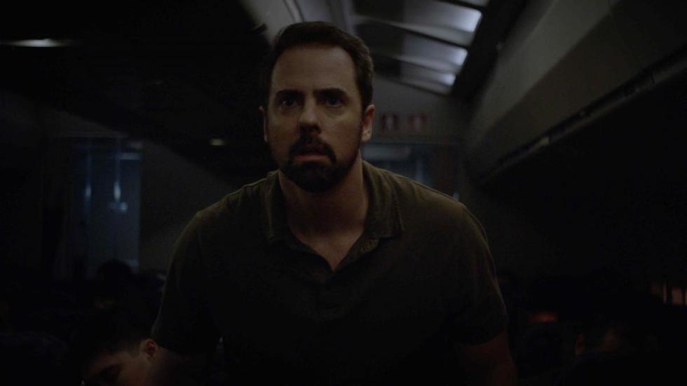 Gregory film still man looks scared in an airplane.