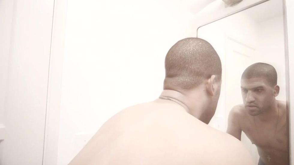 Harmful Sensations man looks at himself in the mirror