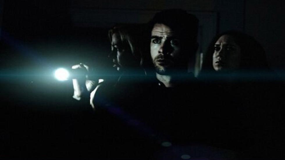 The Tour man guides two women with flashlight