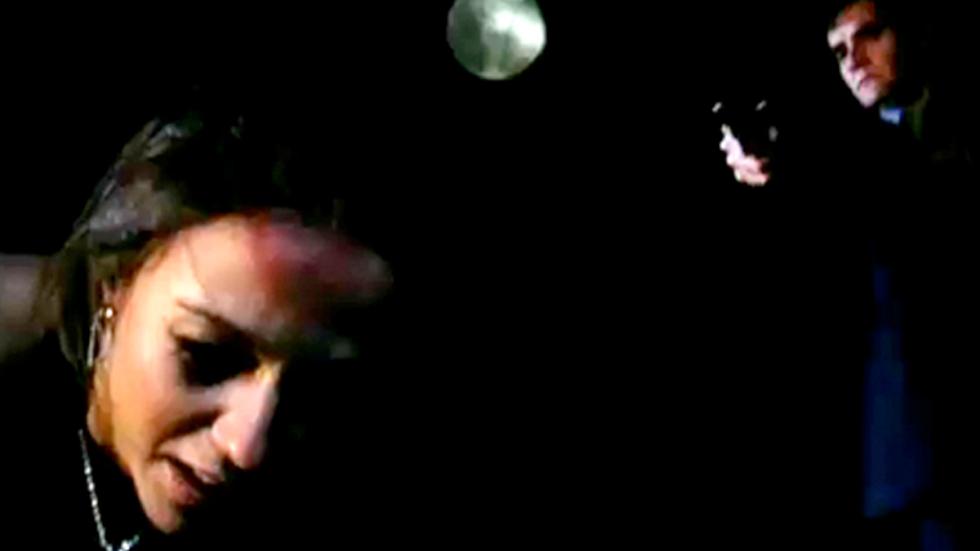 Hunter's Moon man points gun at a woman