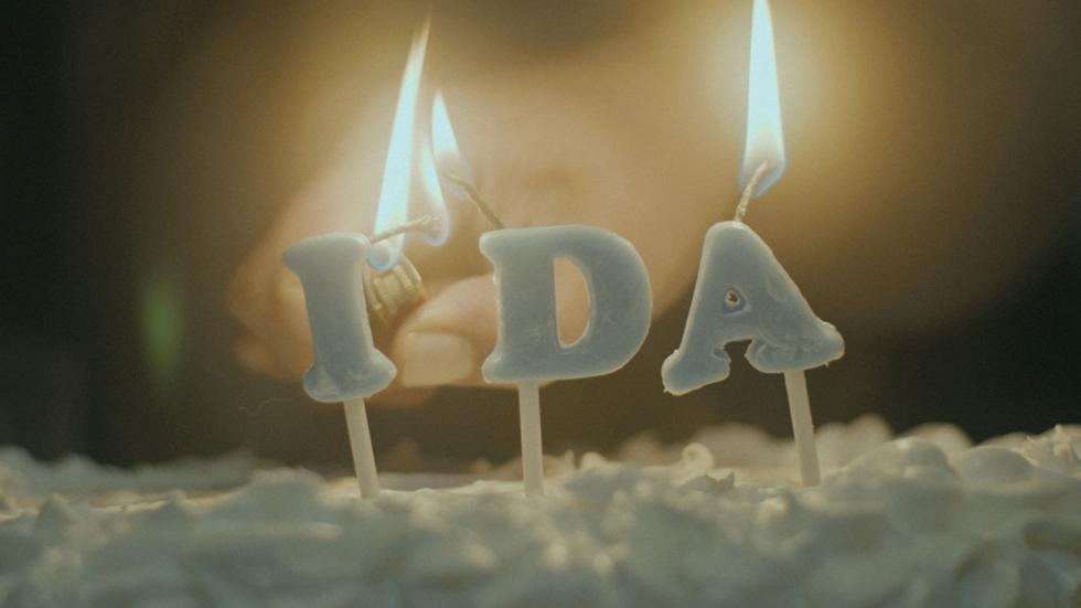 Ida film still candle burning on a cake