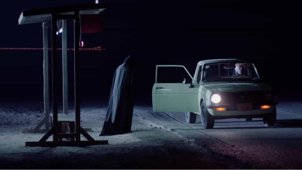 Cloven Film still car opens door to person in a burka
