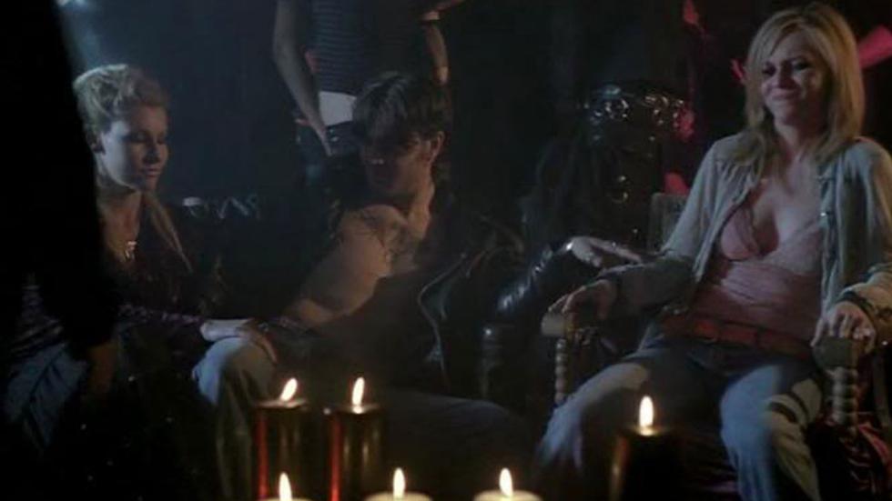 In Twilight's Shadow people sit outdoors at a party