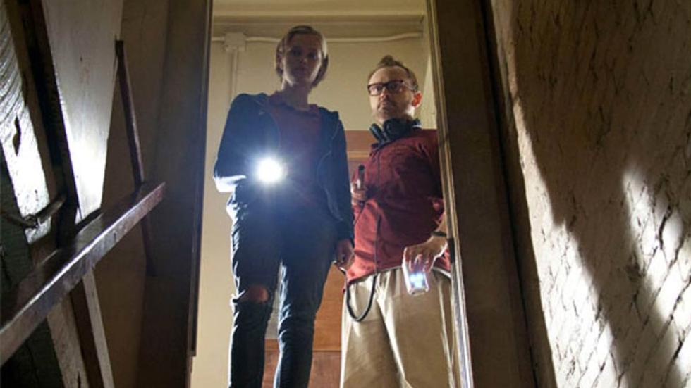 The Innkeepers a couple uses a flashlight to look into the basement